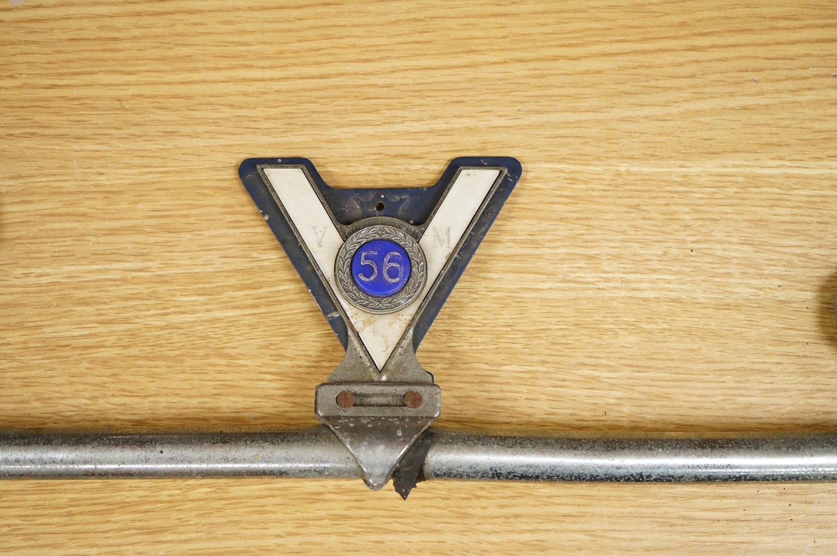 Three car badges to include RAC and AA, mounted on a bar, 67cm in length